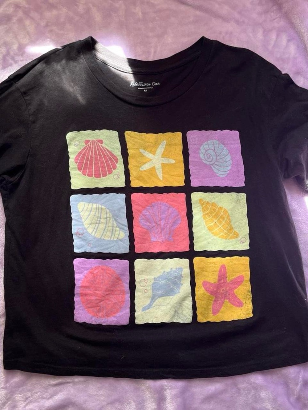Rebellious One Black Tee with Pastel Seashell Grid